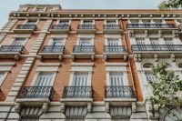 Kaboompics - Ornate Brick and Stone Madrid Apartment Facade with Repeating Wrought-Iron Balconies