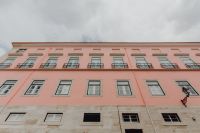 Kaboompics - Low-Angle View of Long Pale Pink Lisbon Facade with Rows of Balconies