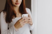 Kaboompics - Beautiful young woman using smartphone
