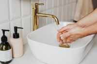 Kaboompics - Rinsing Hands at a White Vessel Sink with Soap Dispensers, Bathroom Hygiene Photography