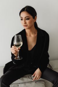 Kaboompics - Asian Woman Holding a White Wine Glass in a Black Outfit