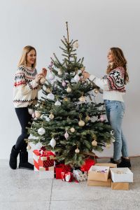 Kaboompics - Two Women Decorating a Christmas Tree Beside Wrapped Gifts