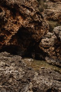 Kaboompics - Rough Dark Rock Surface with Coastal Grass