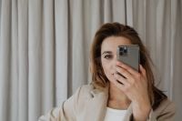 Kaboompics - Businesswoman Taking a Smartphone Selfie in a Neutral Office