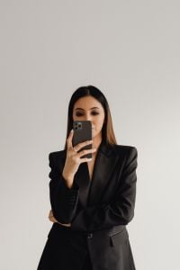 Kaboompics - Businesswoman Taking a Mirror Selfie in a Black Suit