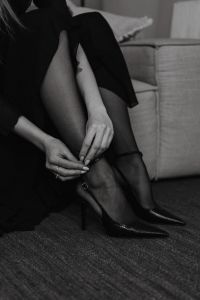 Kaboompics - Black and White Woman Adjusting a Sheer Stocking