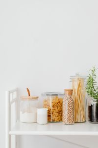 Kaboompics - Minimal Pantry Ingredients Along the Bottom Edge of a Bright White Background