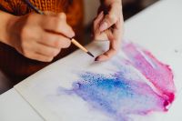 Kaboompics - A woman paints with watercolors