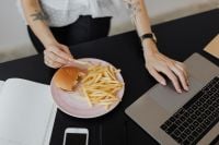 Kaboompics - Working Lunch With Burger, Fries and Laptop at Desk