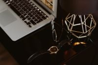 Kaboompics - Laptop Desk Flat Lay with Glasses, Wristwatch and Geometric Gold Lamp