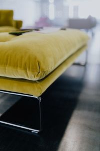 Kaboompics - Neutral Showroom Wall with a Soft-Focus Olive Sofa at the Edge