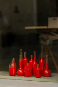 Kaboompics - Red Glass Bottles Displayed in a Dark Italian Shop Window