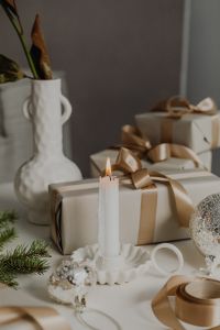 Kaboompics - Neutral Christmas Gift Boxes and Candle with Gray Copy Space, Minimal Holiday Background
