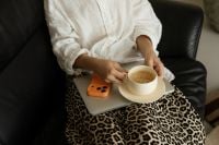 Kaboompics - Woman Holding Coffee With Laptop and Orange Smartphone