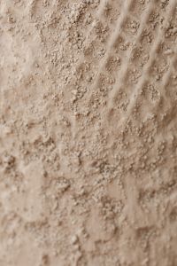 Kaboompics - Beige Plaster Wall Texture with Pebbled Clusters and Diagonal Relief