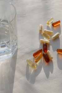 Kaboompics - Vitamin Capsules with Long Shadows on White Linen