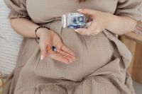Kaboompics - Pregnant Woman Holding Vitamin Supplements Over Her Belly