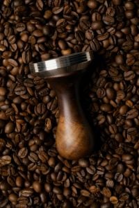 Kaboompics - Coffee Tamper on Roasted Coffee Beans