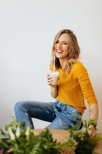 Kaboompics - Joyful Seated Woman Holding a Milkshake