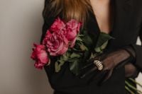 Kaboompics - Black Gloved Hands Holding a Pink Rose Bouquet