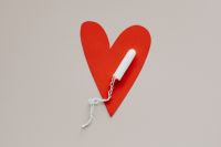Kaboompics - Tampon on Red Heart-Shaped Paper, Menstrual Health Campaign Concept
