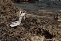 Kaboompics - White Heel Sandal on Coastal Rock with Clear Water
