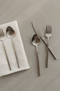 Kaboompics - Modern Silverware Flat Lay with White Napkin and Neutral Copy Space