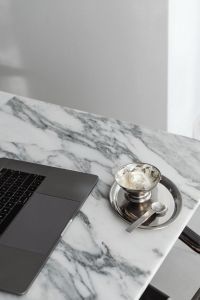 Kaboompics - Laptop Corner and Silver Bowl of Whipped Cream on Veined Marble, Minimal Home Office Food Break