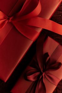 Kaboompics - Burgundy Ribbon Bow on Red Wrapping Paper