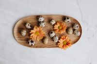 Kaboompics - Quail Eggs and Orange Flowers on a Wooden Tray with Marble Background