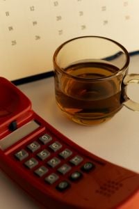 Kaboompics - Retro Red Telephone and Tea With Calendar in Background