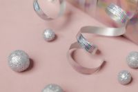 Kaboompics - Silver Baubles and Curling Ribbon on Pink Background