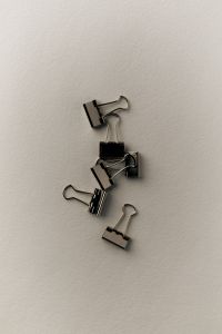 Kaboompics - Black Binder Clips on White Background