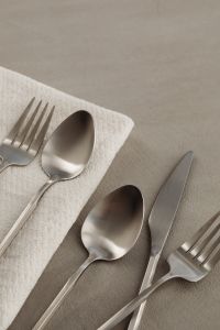 Kaboompics - Matte Steel Fork and Spoon on White Napkin with Neutral Copy Space