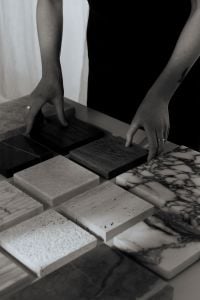 Kaboompics - Monochrome Photo of Hands Arranging Stone and Wood Samples