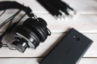 Kaboompics - Smartphone and Headphones on White Plank Surface