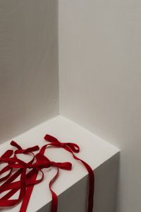 Kaboompics - Red Velvet Ribbon Bows on White Corner Ledge with Copy Space
