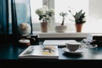 Kaboompics - Magazine on a Desk with Coffee, Laptop, Plants, and Globe
