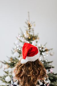 Kaboompics - Woman in Santa Hat by Christmas Tree