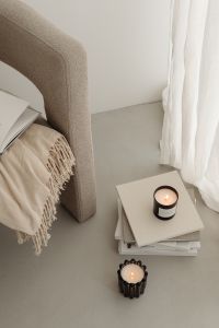 Kaboompics - Two Lit Candles Beside an Armchair and White Curtains