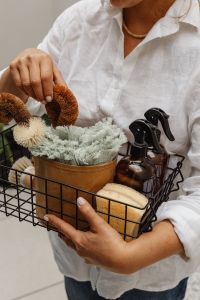 Kaboompics - Home Cleaning Basket with Spray Bottle, Sponge and Dried Flowers