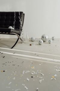 Kaboompics - Disco Balls, Glass Vase and Champagne Cork Beside Chair in Long Shadows
