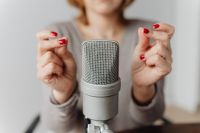 Kaboompics - Close-Up Red Manicure Making Finger-Snap Sounds beside a Studio Microphone