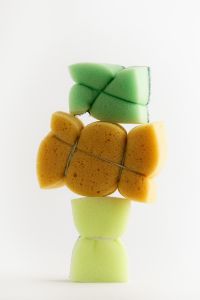 Kaboompics - Green and Yellow Cleaning Sponges Stacked on White, Colorful Household Supplies