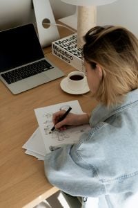 Kaboompics - Close-Up of Designer Drawing Interior Concepts beside Laptop and Coffee