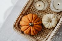 Kaboompics - Flat Lay of Pumpkins and Tealight Candles in a Wicker Tray