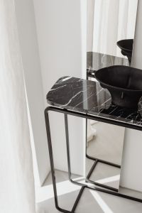 Kaboompics - Black Bowl On Marble Console With Mirror Reflection