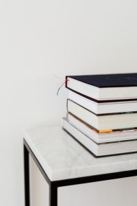 Kaboompics - Side View of Stacked Books and Colorful Page Markers on Marble Table