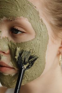 Kaboompics - Close-Up of Brush Spreading Green Clay Mask across the Cheek