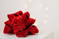 Kaboompics - Red Glitter Gift Bows on White Background with Wide Copy Space